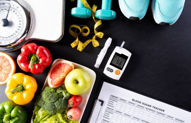 World diabetes day, Healthcare and medical concept. Healthy food including fresh fruits, vegetables, weight scale, sports shoes, dumbells, measure tape and diabetic measurement set on black background.